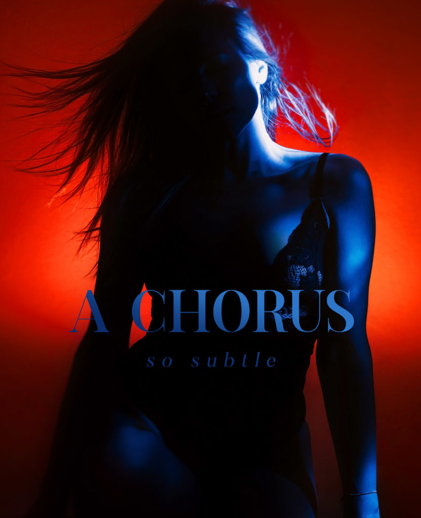 Self portrait with complementary red and blue lighting, hair movement frozen by flash